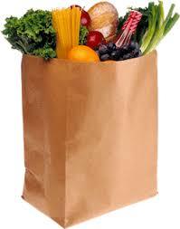 Grocery bag of food with a variety of fruits and vegetables inside